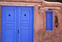 View of blue door and window in adobe structure by Danita Delimont