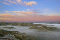 Fog from the Little Missouri River hangs in the badlands of Theodore Roosevelt National Park in North Dakota by Danita Delimont