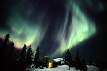 Aurora Borealis in the night sky above a yurt by Danita Delimont
