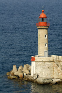 Port lighthouse guards entrance to harbor by Danita Delimont