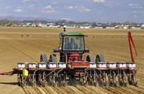 Tractor pulling a seed corn planter von Danita Delimont