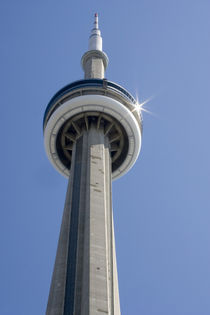 Top of CN Tower with sun star burst reflected on the top disc by Danita Delimont