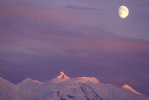 Moon over the alpenglow-lit summit of Mt Silverthrone in the Alaska Range by Danita Delimont