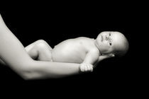 Naked baby in father hands by Waldek Dabrowski