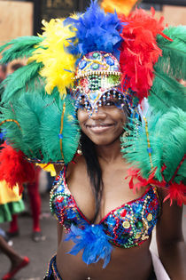 Very colourful feathery headgear at the Notting Hill Carnival. by Tom Hanslien