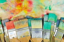 Stack of colorfull paintbrushes on palette by Sami Sarkis Photography