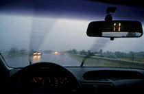 Inside a speeding car on a highway under rain by Sami Sarkis Photography