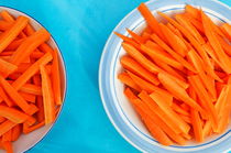 Cutted carrots on table by Sami Sarkis Photography