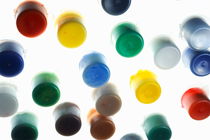Multi-colored small plastic paint pots by Sami Sarkis Photography