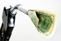 One US banknote coming out petrol pump nozzle by Sami Sarkis Photography