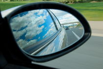 Side-view mirror reflecting clouds by Sami Sarkis Photography