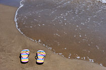 Flip-flops on beach by Sami Sarkis Photography