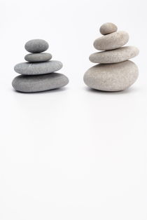 Two stacks of white and gray pebbles by Sami Sarkis Photography