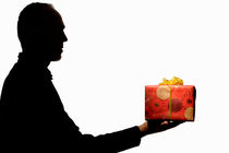 Silhouette of man holding gift by Sami Sarkis Photography