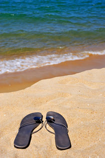 Sandals on beach by Sami Sarkis Photography