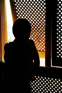 Silhouette of woman at Moucharabieh window by Sami Sarkis Photography