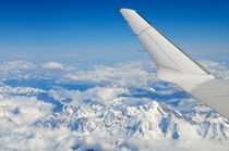 Wings of flying airplane over French Alps by Sami Sarkis Photography
