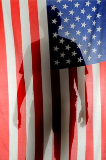 Silhouette of man behind US Flag by Sami Sarkis Photography