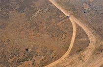 Car on dirt road in desert von Sami Sarkis Photography