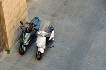 Two parked motor scooters by wall by Sami Sarkis Photography