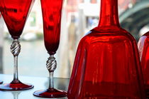 Red glasses on shelves in Murano by Sami Sarkis Photography