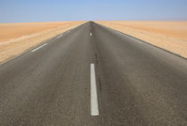 Straight road in desert by Sami Sarkis Photography