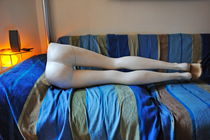 Mannequin legs lying on sofa in living room by Sami Sarkis Photography
