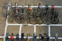 Bicycles parked on street by Sami Sarkis Photography