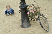 Girl playing with sand near bicycle by Sami Sarkis Photography