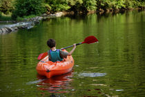 Boy kayaking in river by Sami Sarkis Photography