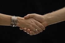 Man and woman shaking hands by Sami Sarkis Photography