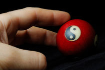 Hand on meditation ball with Yin Yang symbol by Sami Sarkis Photography