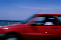Red car speeding along the Corniche du Président J.F. Kennedy von Sami Sarkis Photography