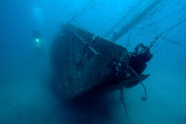 Scuba diver exploring  Le Voilier Shipwreck by Sami Sarkis Photography