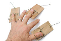 Man's hand with three mousetraps on fingers by Sami Sarkis Photography