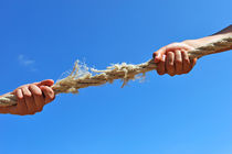 Teenagers hands playing tug-of-war with used rope by Sami Sarkis Photography