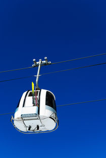 Overhead cable car against blue sky by Sami Sarkis Photography
