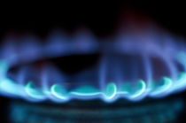 Lit blue gas stove burner by Sami Sarkis Photography