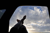 Woman's legs barefeet out of car window by Sami Sarkis Photography