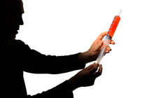 Man's silhouette holding  a  big syringe by Sami Sarkis Photography
