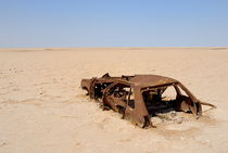 Abandoned and rusty car wreck in desert by Sami Sarkis Photography