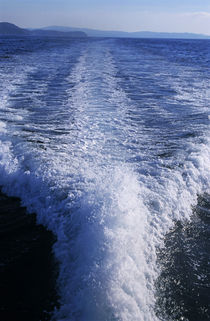 Water trail behind speedboat at sea by Sami Sarkis Photography