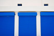 Three blue closed shutters by Sami Sarkis Photography