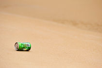 Soda can on beach by Sami Sarkis Photography
