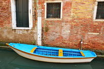 Row boat by old bricks wall and canal by Sami Sarkis Photography