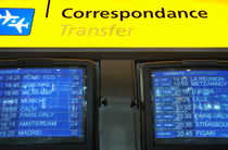 Departure screens and transfer sign at airport by Sami Sarkis Photography
