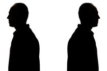 Silhouette of two men back to back by Sami Sarkis Photography