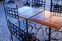 Wrought iron chairs and wooden tables in cafe von Sami Sarkis Photography