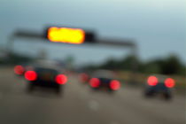 Blurred tail lights of cars travelling on a highway by Sami Sarkis Photography