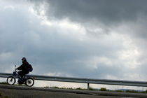 Moped on a road against a stormy sky by Sami Sarkis Photography